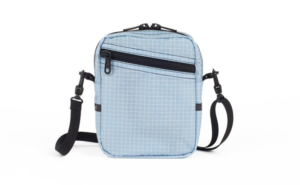 An Everyday Cubelet in Acuity Halcyon (light blue with a white grid) with a front zipper.